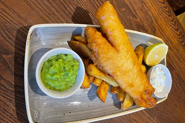 Fish served with chips, mushy peas and tartar sauce